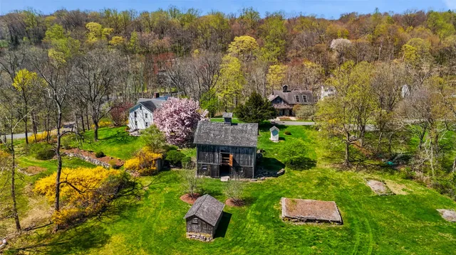 an aerial view of a house with yard swimming pool and mountain view