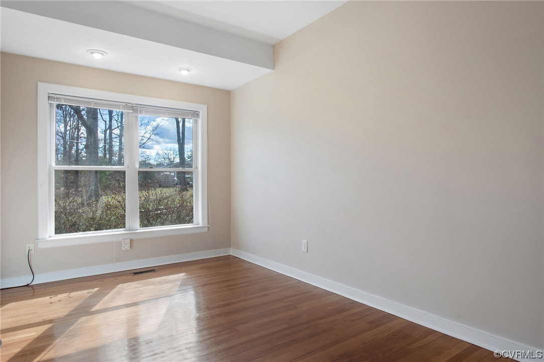 901 Hockett Road Manakin-Sabot, VA 23103 - Photo 19 of 39 an empty room with wooden floor and windows