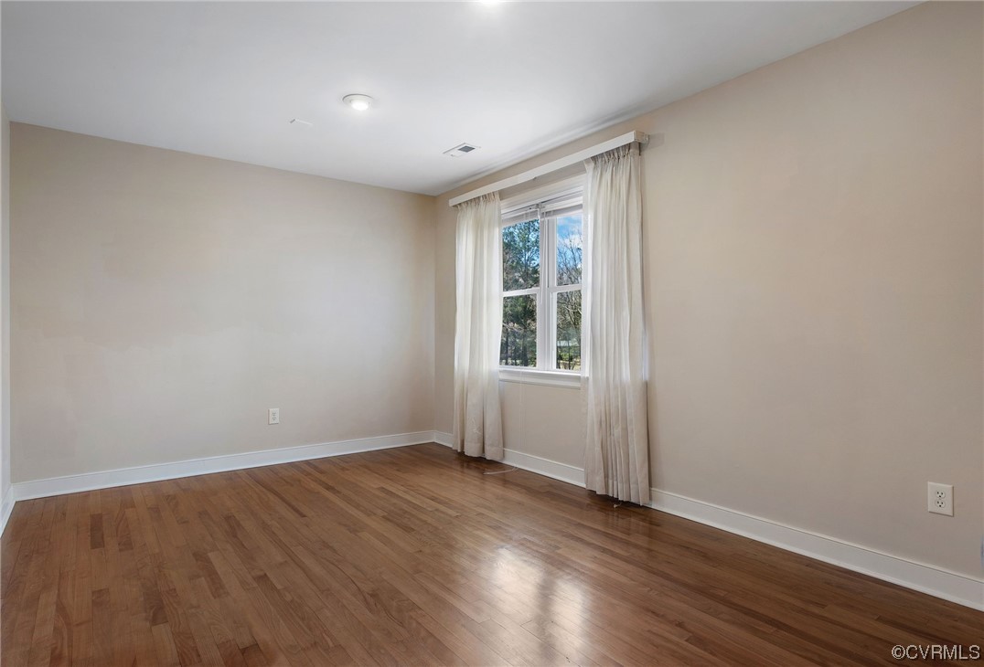 901 Hockett Road Manakin-Sabot, VA 23103 - Photo 27 of 39 an empty room with wooden floor and windows
