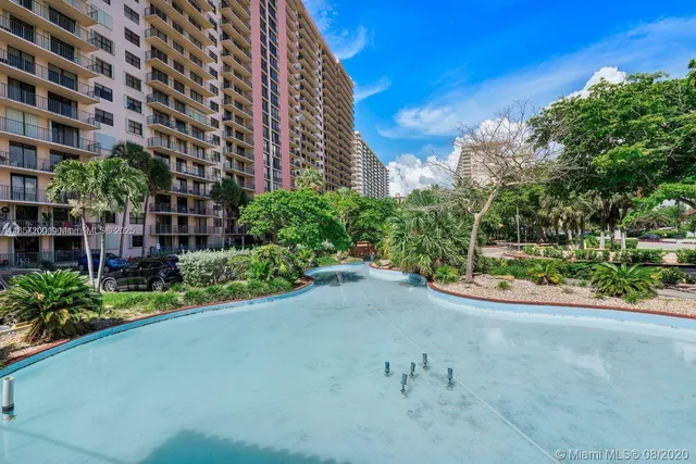 a view of a garden with a building in the background