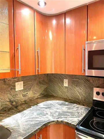 a view of a kitchen with a sink and wooden floor