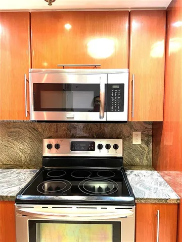 a stove top oven sitting inside of a kitchen