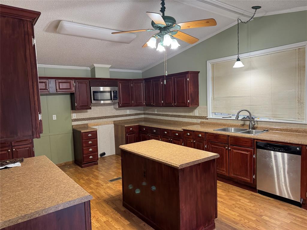 220 Robinson Road Elm Grove, LA 71051 - Photo 14 of 22 a kitchen with stainless steel appliances granite countertop a sink a stove and a wooden cabinets