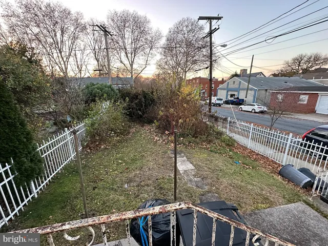 a view of a house with a backyard and a tree