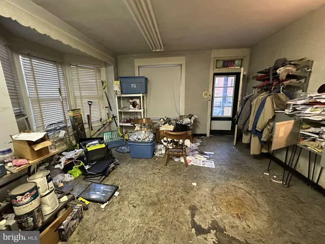 a living room filled with furniture gym equipment and a window