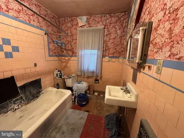 walk in closet with wooden floor and chair