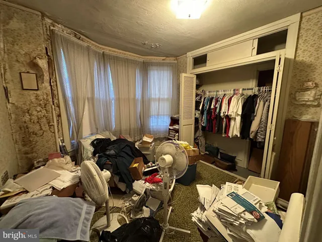 a bed room with a bed and a chair