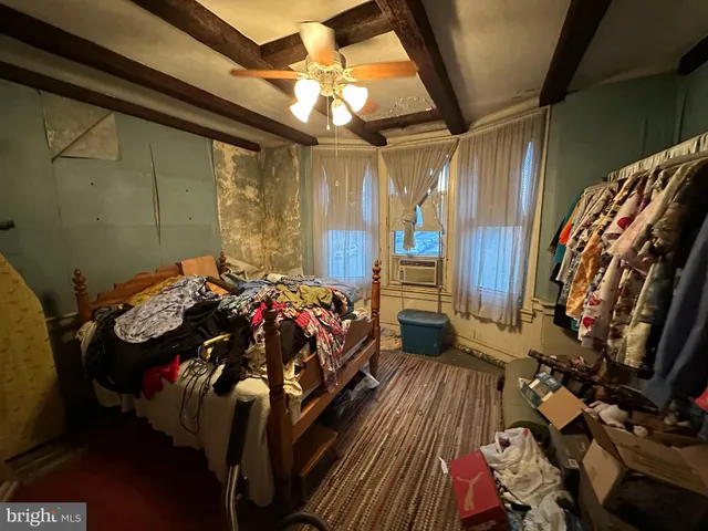 a bedroom with a bed and a mirror