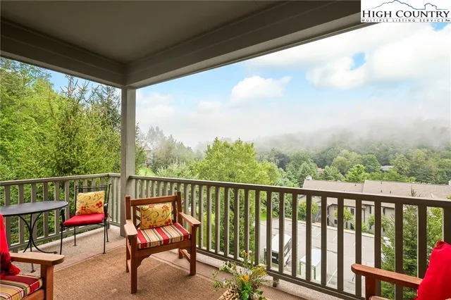 a view of a two chairs in the balcony