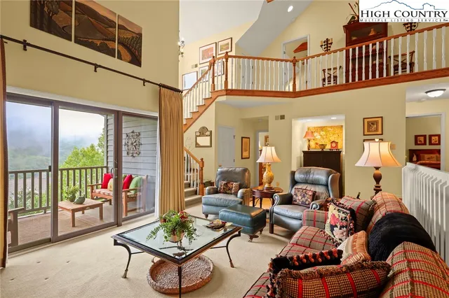 a living room with furniture a rug and a window