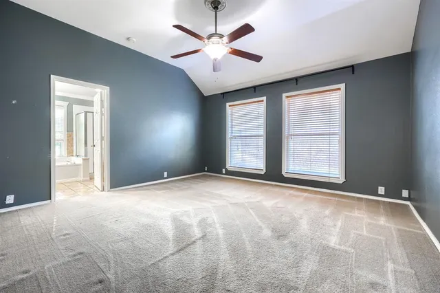 a bathroom with a granite countertop sink and a bathtub