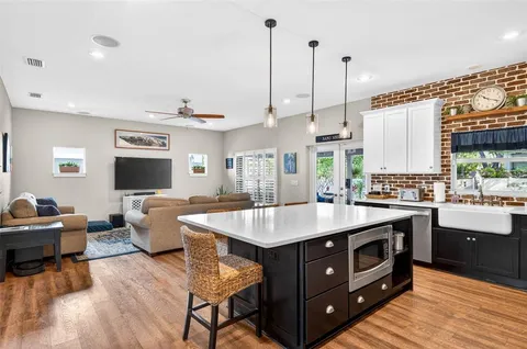 a open kitchen with stainless steel appliances granite countertop a stove and refrigerator
