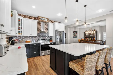 a open kitchen with stainless steel appliances kitchen island a large counter top and stainless steel appliances