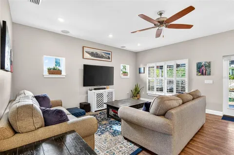 a living room with furniture and kitchen view
