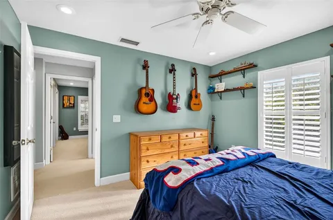a bathroom with a granite countertop sink a toilet and shower