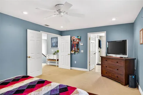 a view of a patio with a dining table and chairs with a couches near a water fountain