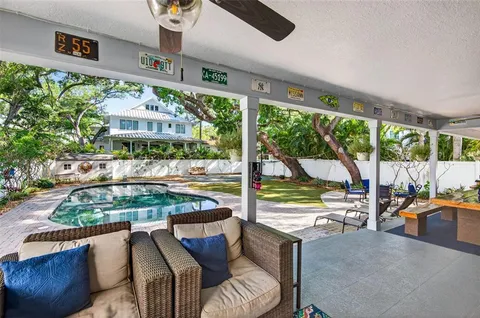 a swimming pool with outdoor seating and yard