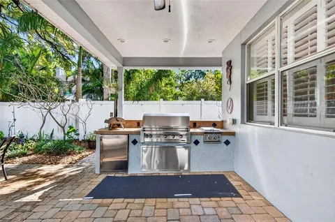 an aerial view of a house with a yard and outdoor seating