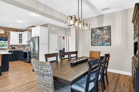 a living room with lots of furniture and kitchen view