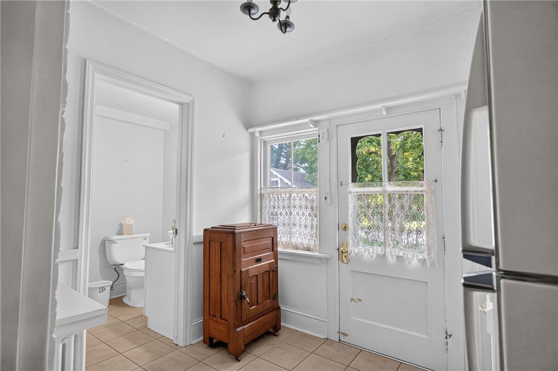 765 East Macada Road Bethlehem, PA 18017 - Photo 19 of 46 A well-lit area features a powder room, exterior door, and window with charming lace curtains.