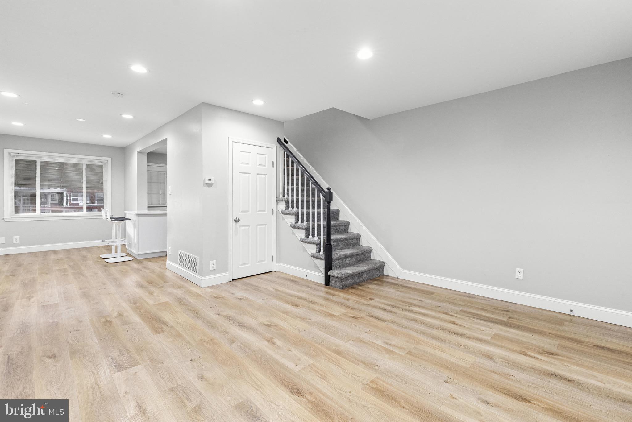 2203 Redthorn Road Baltimore, MD 21220 - Photo 4 of 23 a view of an empty room with wooden floor and stairs