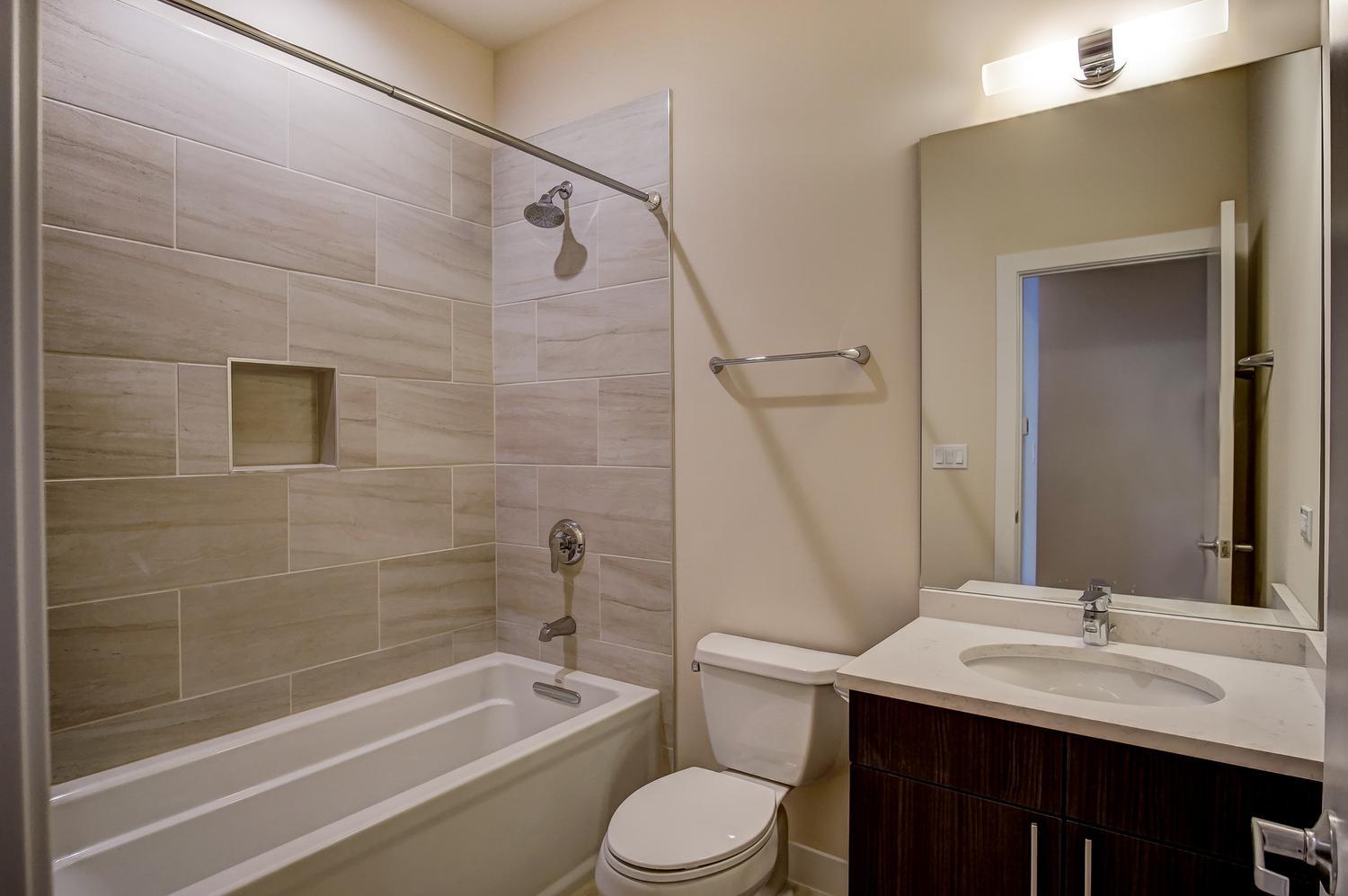 2532 West Addison Street, Unit 1W Chicago, IL 60618 - Photo 12 of 24 a bathroom with a sink a toilet and shower