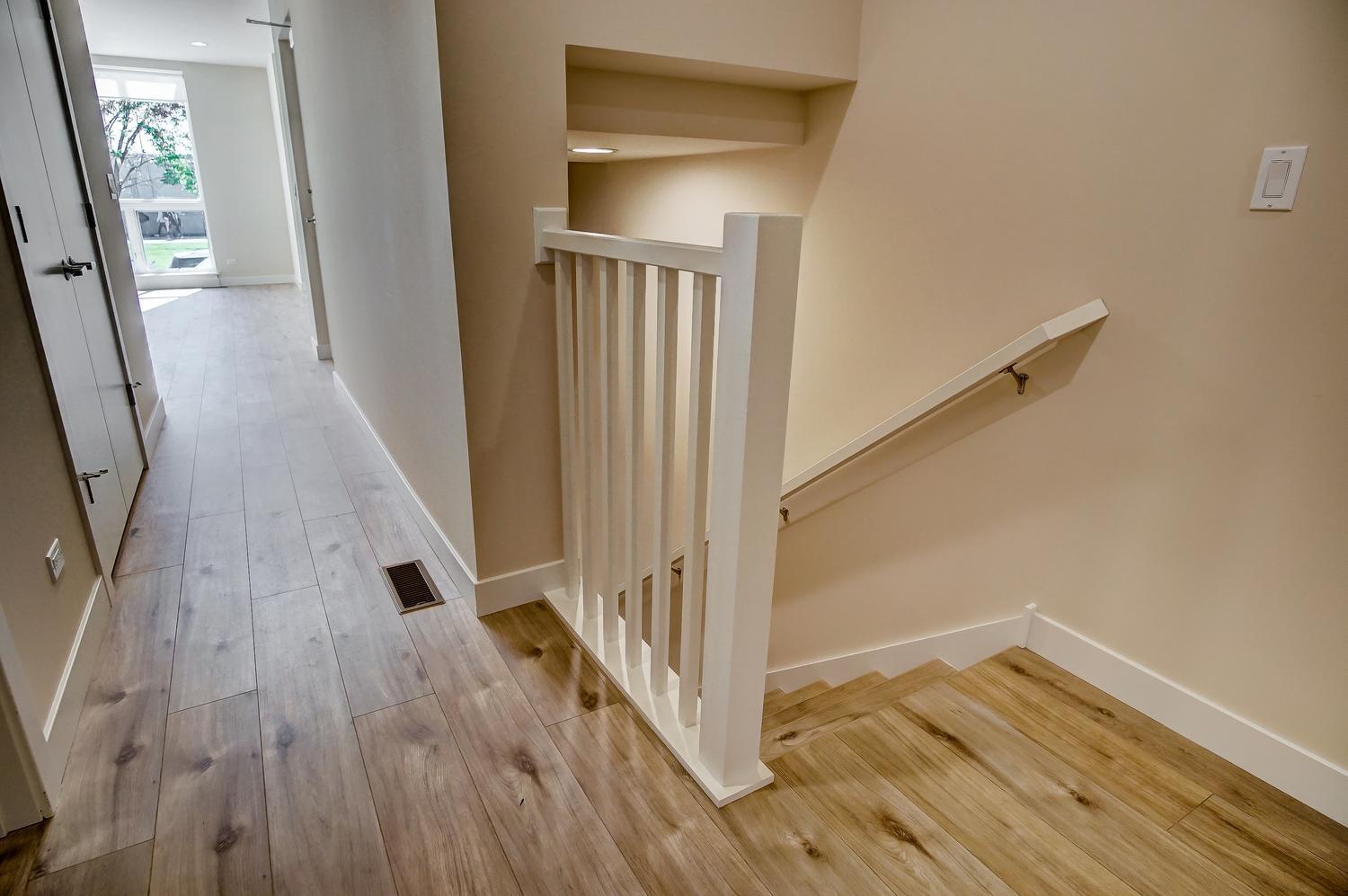 2532 West Addison Street, Unit 1W Chicago, IL 60618 - Photo 13 of 24 a view of a hallway with wooden floor and staircase