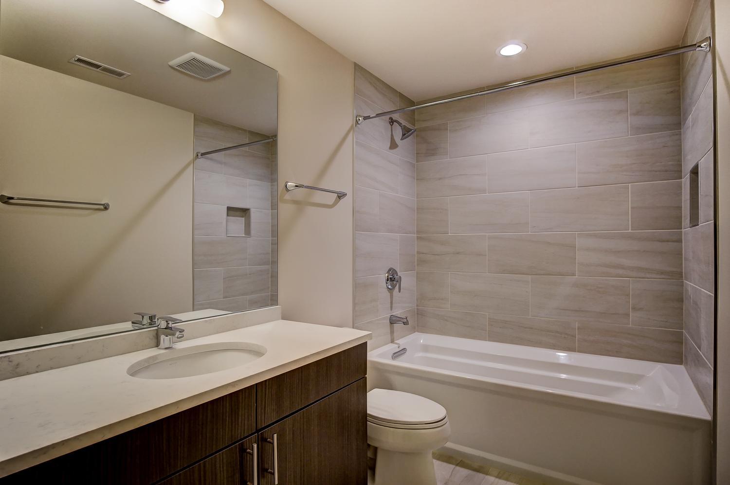 2532 West Addison Street, Unit 1W Chicago, IL 60618 - Photo 18 of 24 a bathroom with a sink a toilet and a bathtub