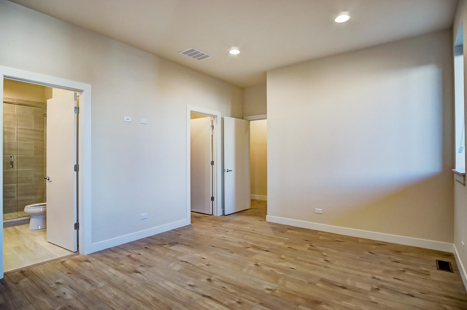 2532 West Addison Street, Unit 1W Chicago, IL 60618 - Photo 7 of 24 an empty room with wooden floor and bathroom