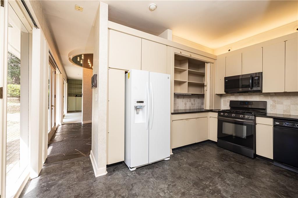 3248 Nancy Creek Road Northwest Atlanta, GA 30327 - Photo 20 of 44 a kitchen with stainless steel appliances a refrigerator and a stove top oven