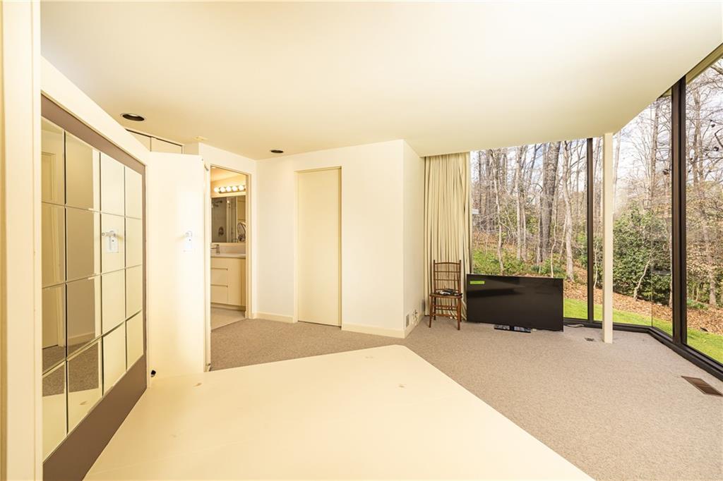 3248 Nancy Creek Road Northwest Atlanta, GA 30327 - Photo 26 of 44 a spacious bedroom with a large bed and a large window