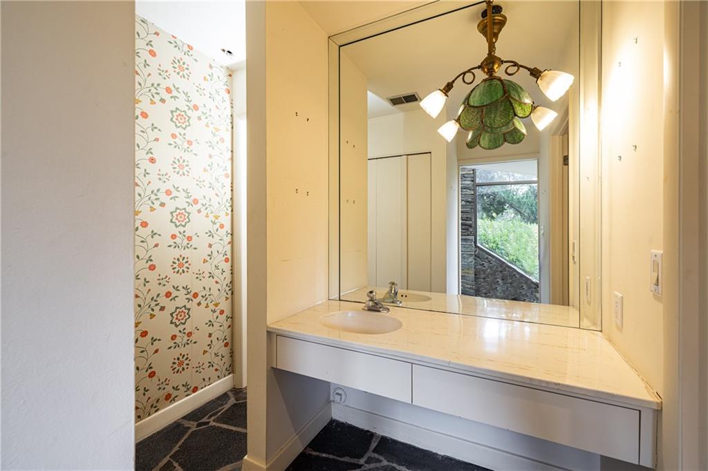 3248 Nancy Creek Road Northwest Atlanta, GA 30327 - Photo 37 of 44 a bathroom with a sink and a mirror