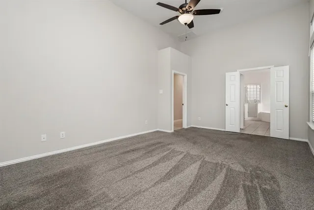 a view of a room with a ceiling fan
