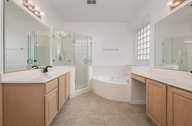 a spacious bathroom with a double vanity sink mirror double and bathtub