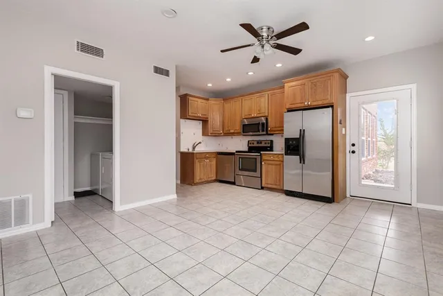 a kitchen with stainless steel appliances a refrigerator sink and cabinets