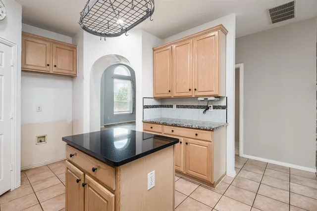 a kitchen with granite countertop a stove and a sink