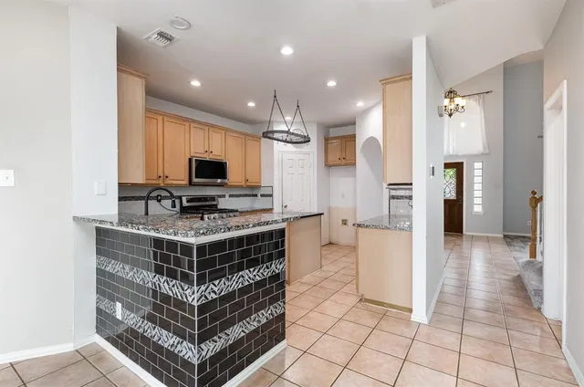 a view of kitchen with cabinets and refrigerator