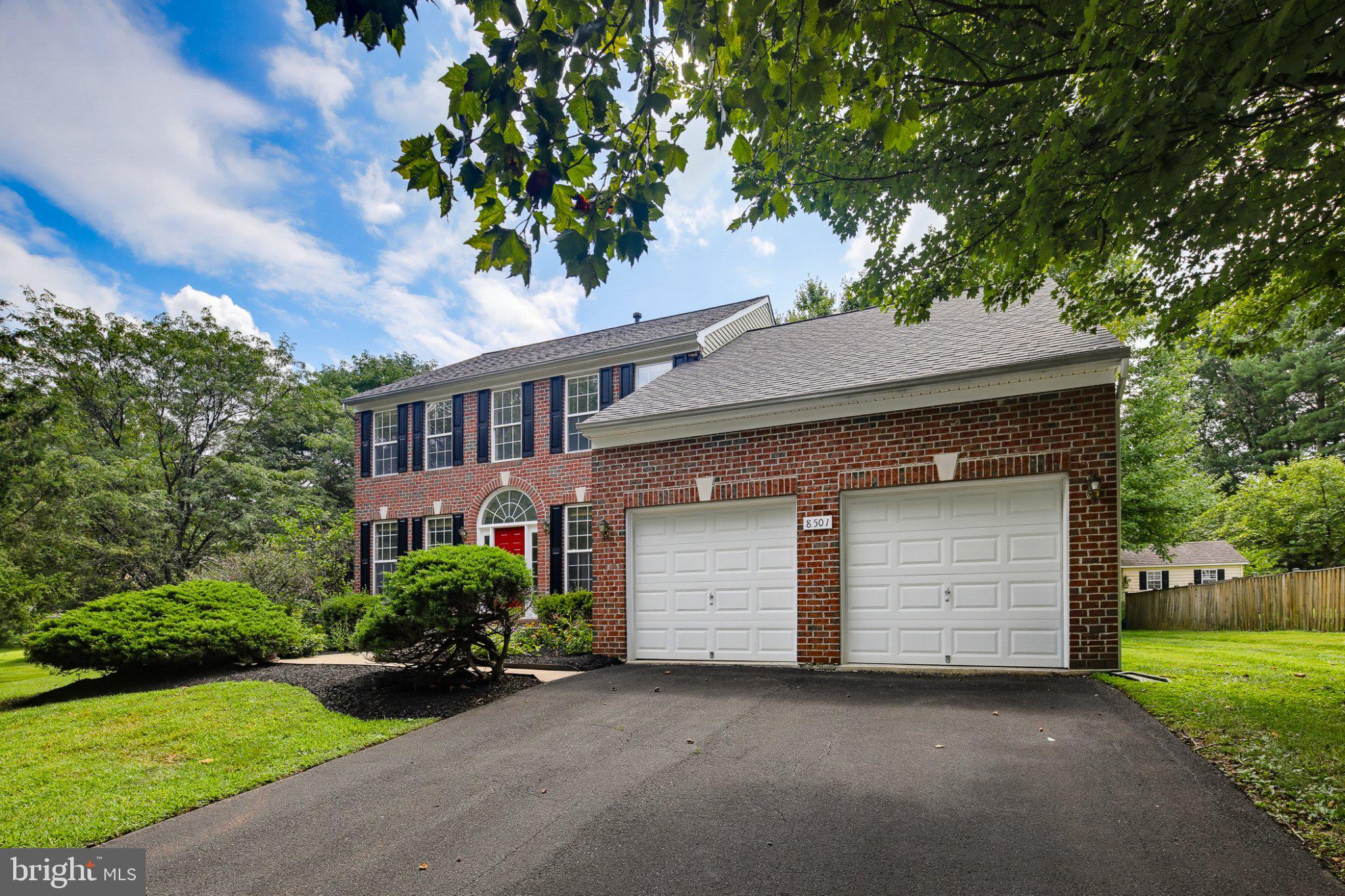 8501 Springway Road Ellicott City, MD 21043 - Photo 43 of 44 Charming brick home with lush greenery.
