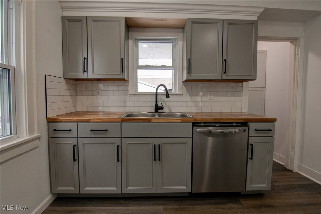 3357 Kildare Road Cleveland, OH 44118 - Photo 9 of 26 Kitchen featuring dark hardwood / wood-style floors, butcher block countertops, sink, gray cabinetry, and stainless steel dishwasher