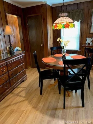 a view of a dining room with furniture and a chandelier