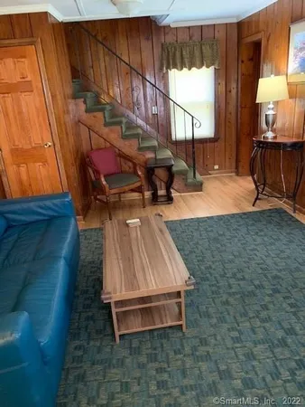 a living room with furniture a window and a flat screen tv