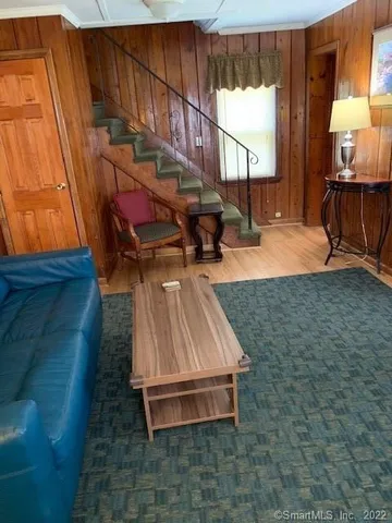 a living room with furniture a window and a flat screen tv