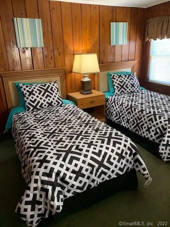 a bedroom with a bed and a chair