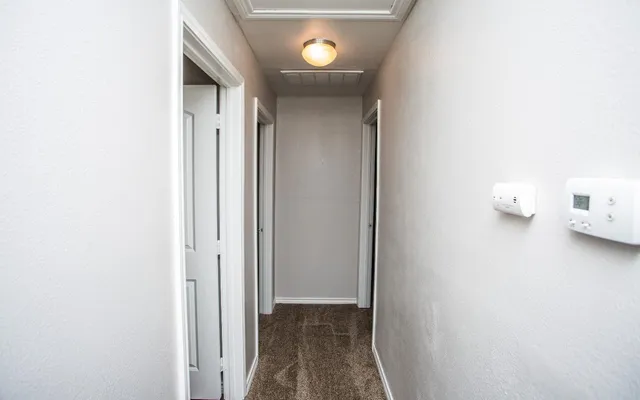 a view of a hallway with wooden floor