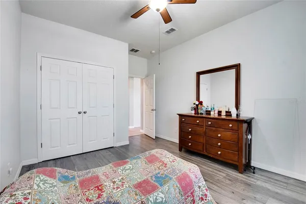 a bedroom with a bed and a mirror on dresser
