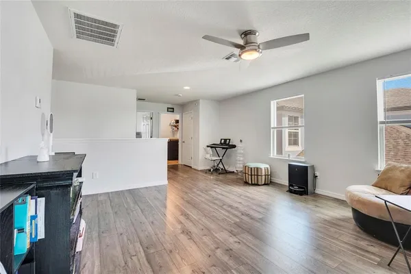 a living room with furniture and a wooden floor