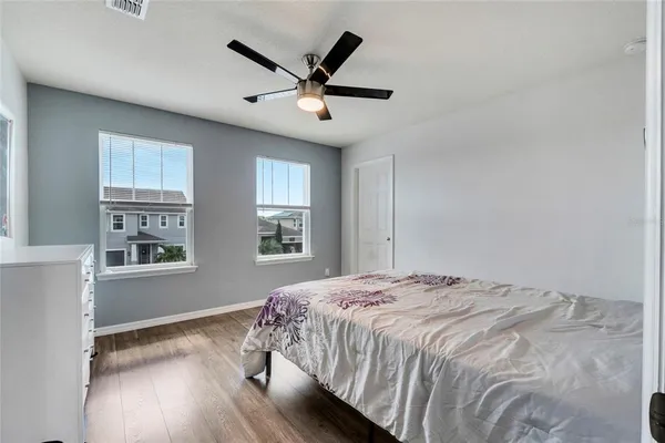 a bedroom with a large bed and a window