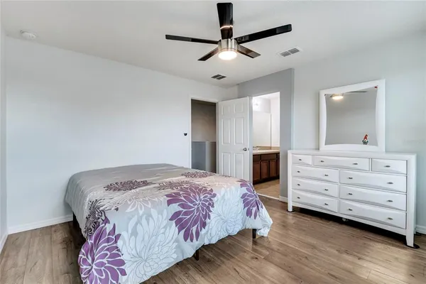 a bedroom with a bed and a dresser