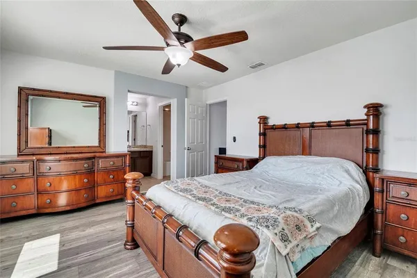 a bedroom with a bed and a dresser