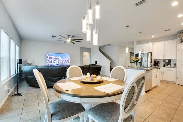a dining room with furniture and a chandelier